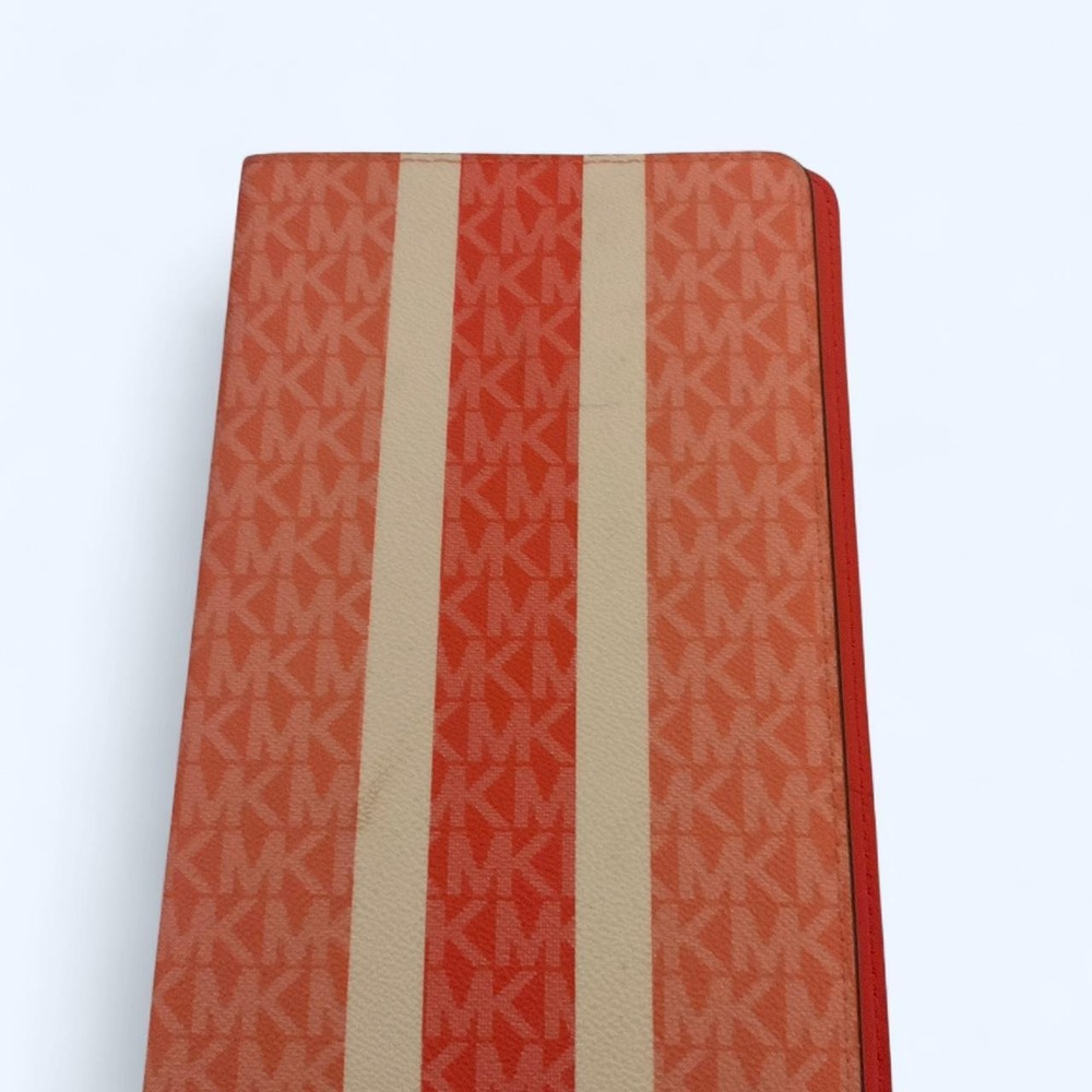 MK pink/red leather organizer/planner cover with repeating MK monogram pattern
